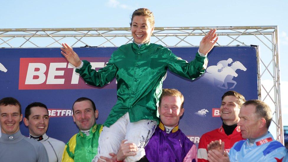 Hayley Turner on shoulders of other jockeys