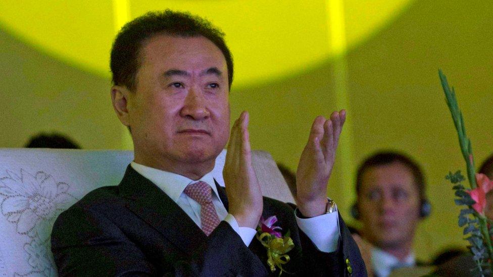 In this June 19, 2013, file photo, Wanda Chairman Wang Jianlin applauds during an event at a hotel in Beijing, China.