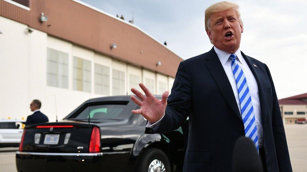 US President Donald Trump speaks to reporters ahead of a rally in West Virginia, 21 August 2018