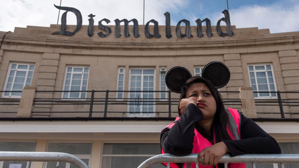 A steward is seen outside Banksy's 'Dismaland' exhibition, which opened at a derelict seafront lido on August 20, 2015 in Weston-Super-Mare