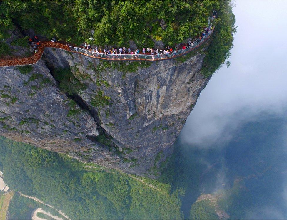 People walk on a sightseeing platform in Zhangjiajie, Hunan Province, China, 1 August 2016.