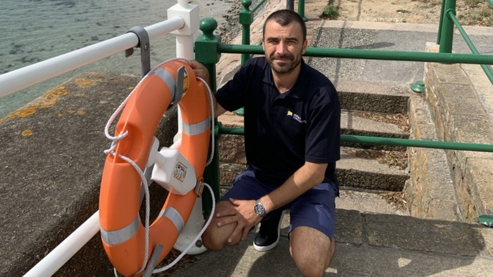 Coastguard with lifebuoy