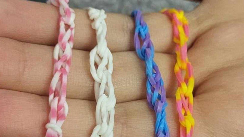 Four Loom bracelets on a hand