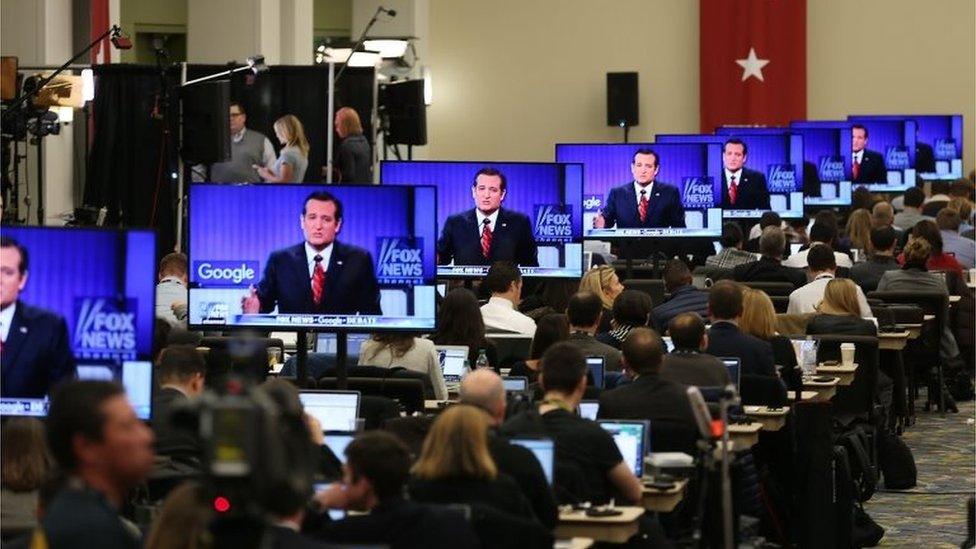 Republican Presidential candidate Sen. Ted Cruz (R-TX) is seen on a television screen as reporters watch the Republican Presidential debate sponsored by Fox News and Google at the Iowa Events Center on 28 January 2016 in Des Moines, Iowa