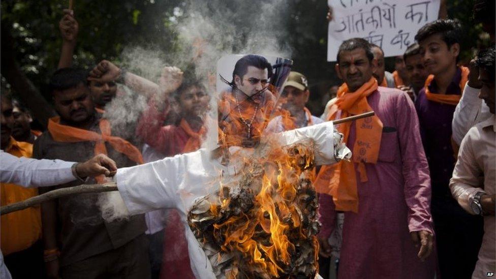 A small group of right wing Hindu activists burn an effigy of Bollywood star Salman Khan in New Delhi, India, Sunday, July 26, 2015. The activists were reacting to the actor's tweet in support of Yakub Memon, death row convict in the 1993 Mumbai blasts case.