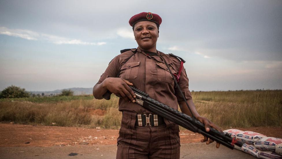 Vigilante Group of Nigeria, Barkin Ladi Division member Sarah Dung, 39, guards a check point in Barkin Ladi, Nigeria on Wednesday, October 24, 2018.