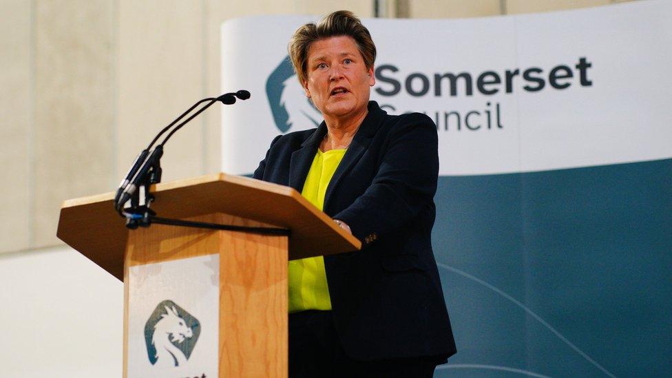 Sarah Dyke standing at a lectern giving a speech