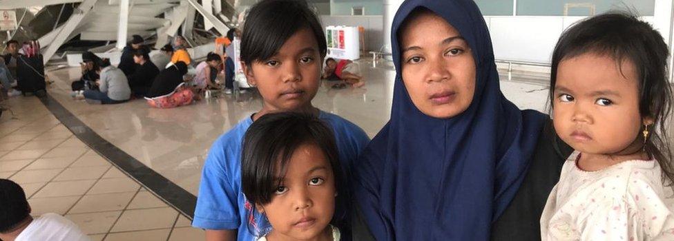 Wasliha and her three children at the airport