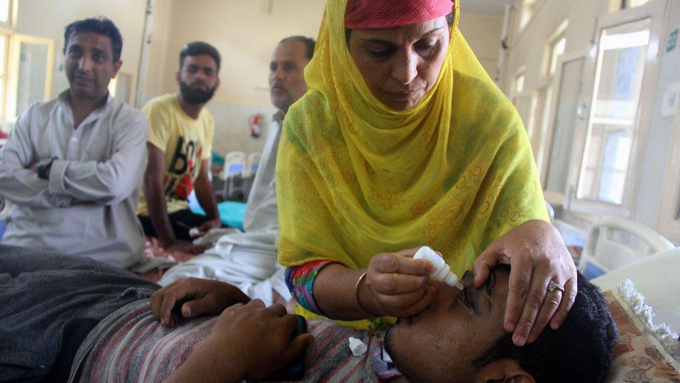 A patient receives medicine after receiving eye injuries