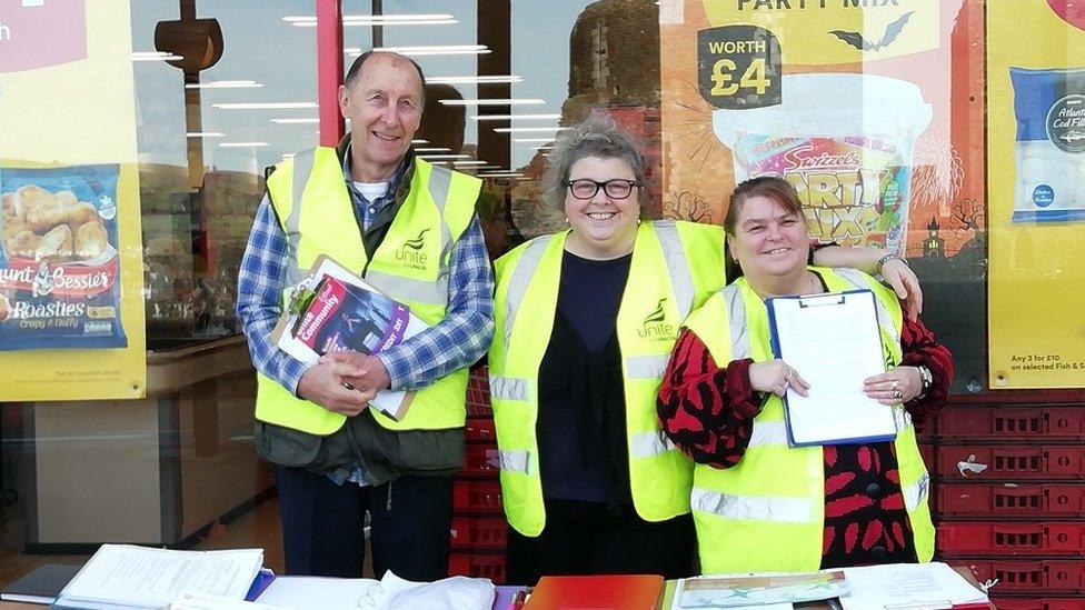 left to right - Alan, Sue and Kay behind a table advertising help with ESA claim problems