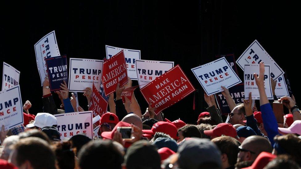 trump signs at a rally