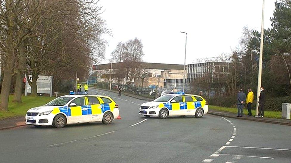 Police vehicles at the plant