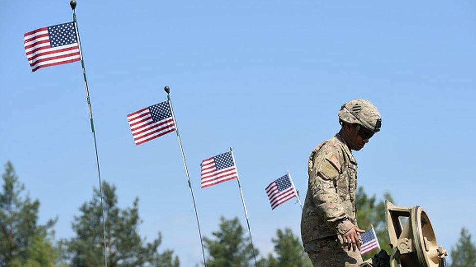 A US soldier stands at a tank in a training area in Grafenwoehr, near Eschenbach, southern Germany