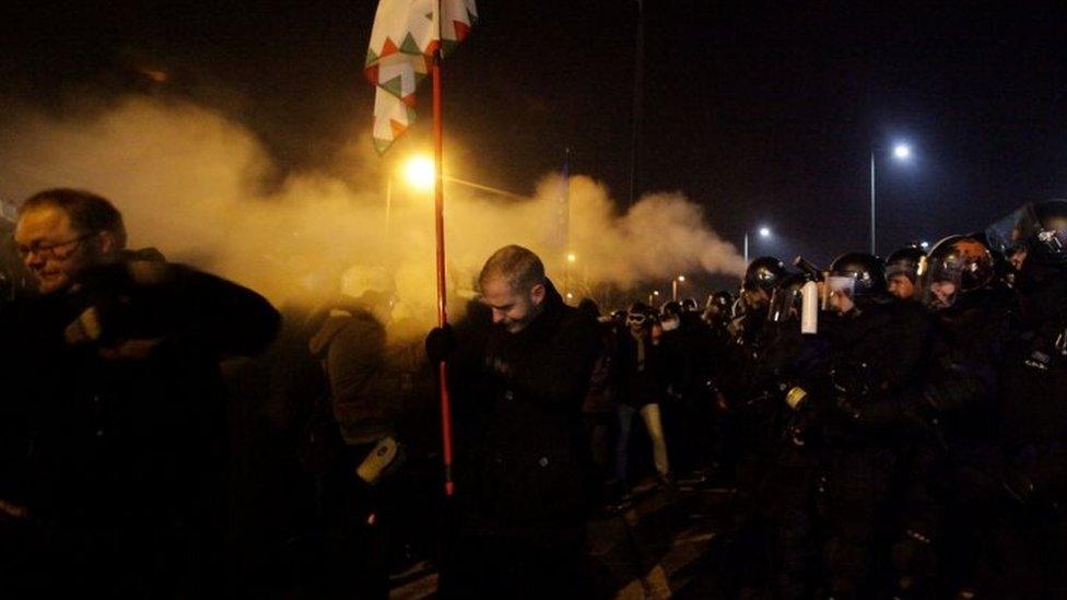 Police fire tear gas to disperse protesters outside the state TV headquarters in Budapest. Photo: 16 December 2018