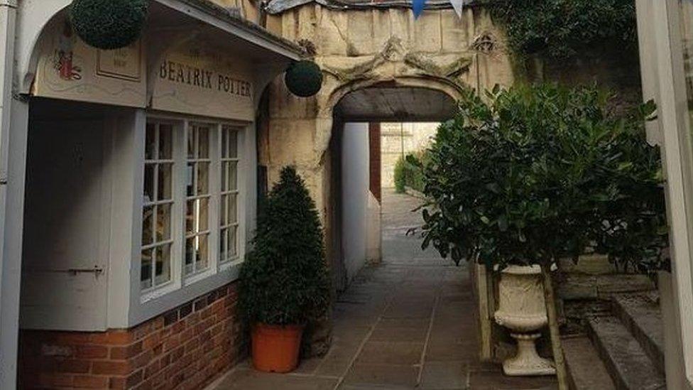 Photo of the narrow street on which the House of the Tailor of Gloucester sits