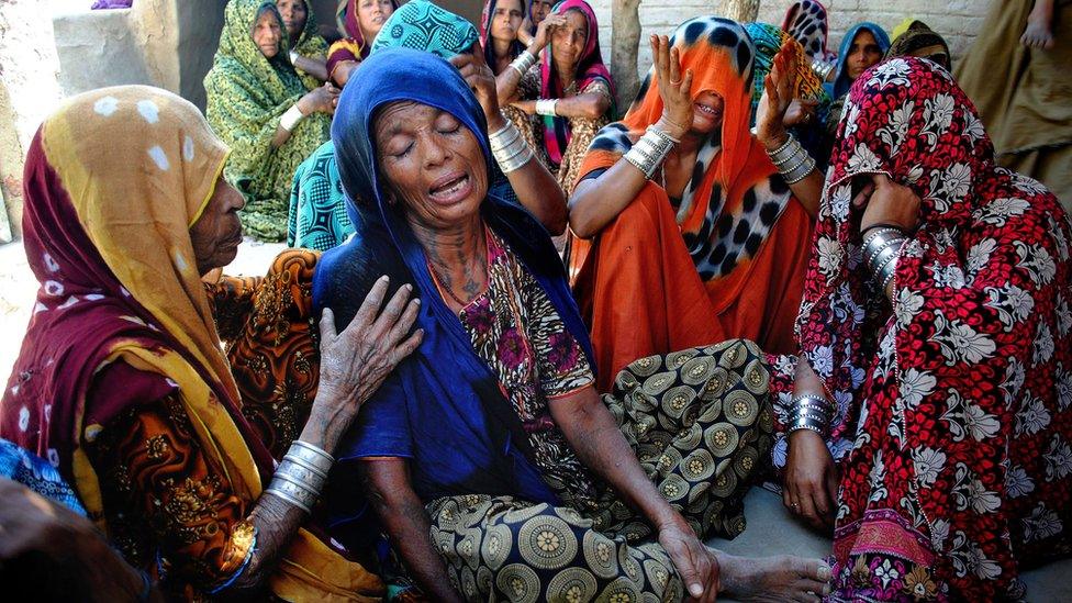 Pakistani Hindu women mourn the deaths of their family members in Tando Muhammad Khan near Hyderabad, Tuesday, March 22, 2016