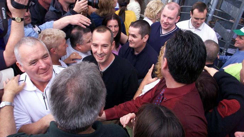 IRA prisoners on early release emerge through the Maze Prison turnstile in 2000