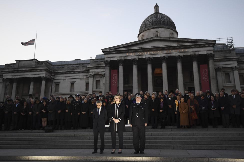 Mayor of London Sadiq Khan, Home Secretary Amber Rudd MP and acting Commissioner of the Metropolitan Police Craig Mackey stand in silence during a candlelit vigil at Trafalgar Square