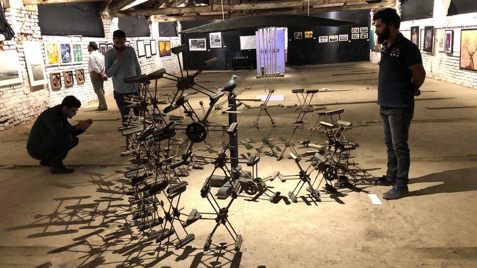 People looking at an art installation at the exhibit