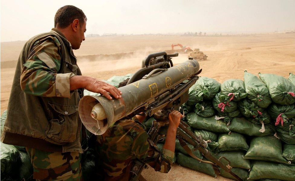 A Kurdish Peshmerga fighter pictured with a Milan anti tank weapon guards against possible Islamic State suicide bomb attacks during a battle with Islamic State militants at Topzawa village, near Bashiqa, near Mosul, Iraq.