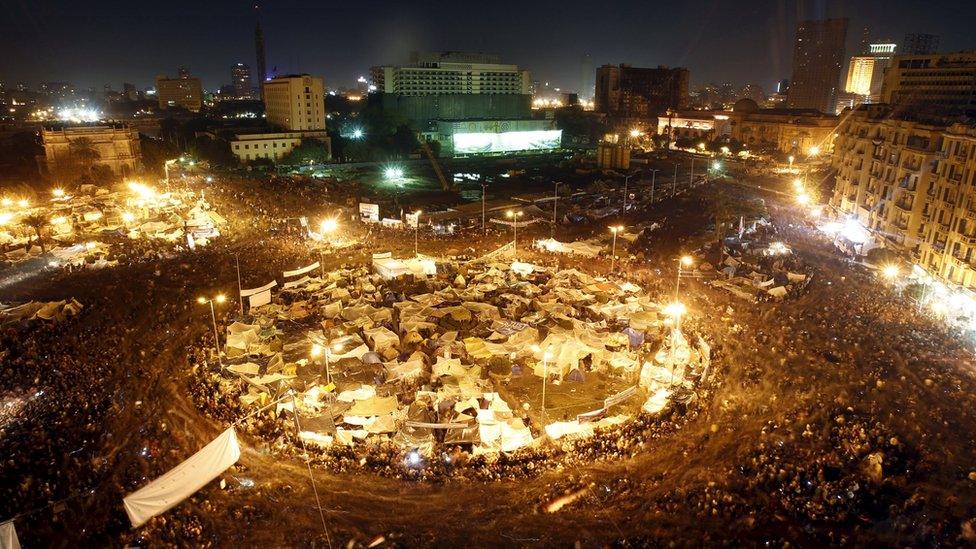 Anti-government protesters in Cairo's Tahrir Square listen as President Hosni Mubarak speaks to the nation on 10 February 2011