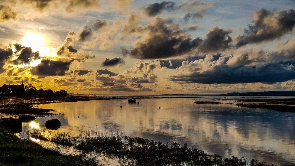 The sun setting at Whiteford on the Gower