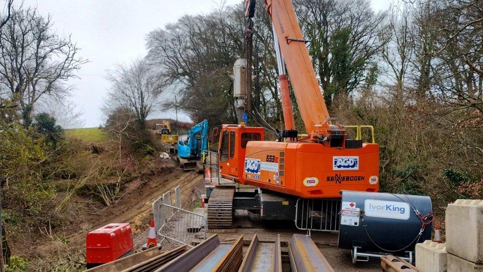 Orange crane being used during the works