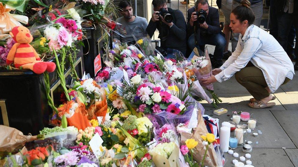 a member of the public lays flowers in Manchester