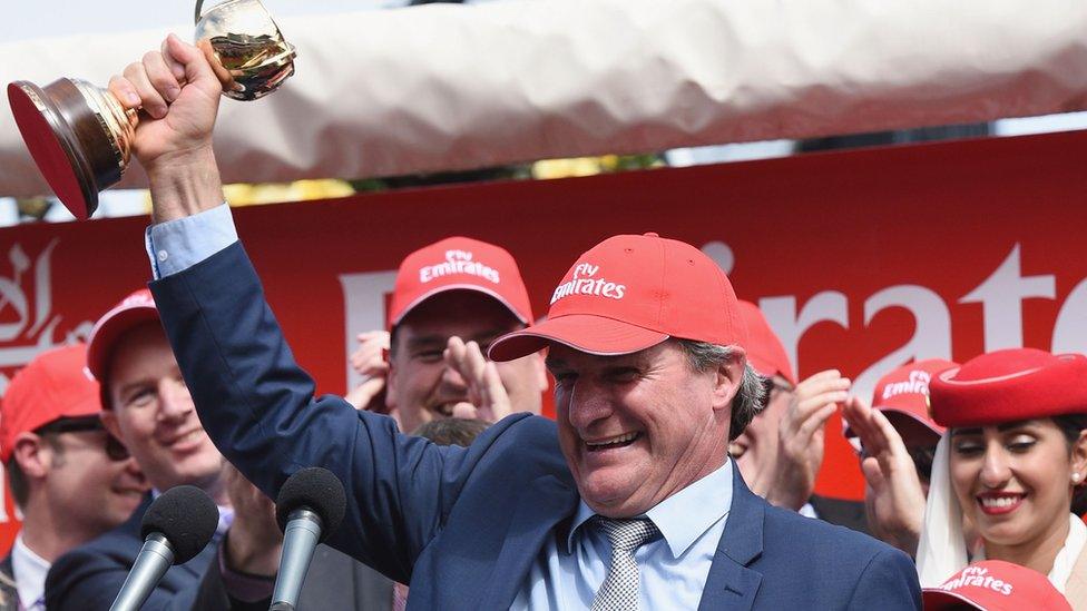 Darren Weir holding the Melbourne Cup trophy after his win in 2015