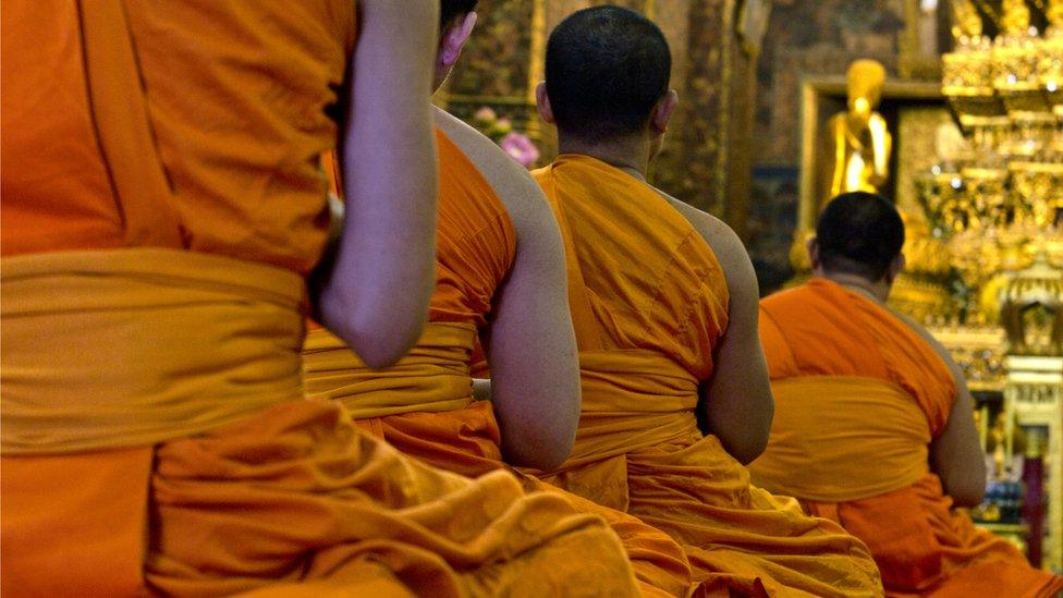 Buddhist monks praying