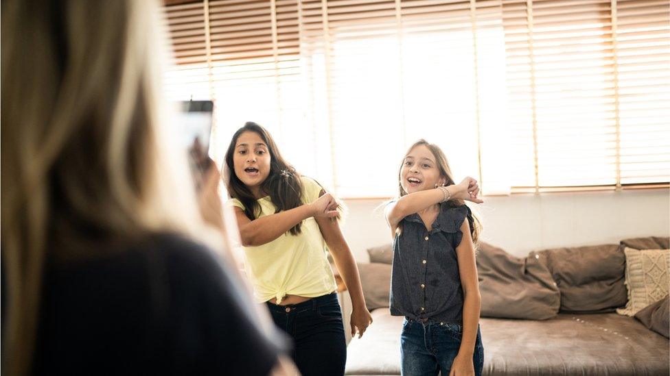 Children being filmed dancing