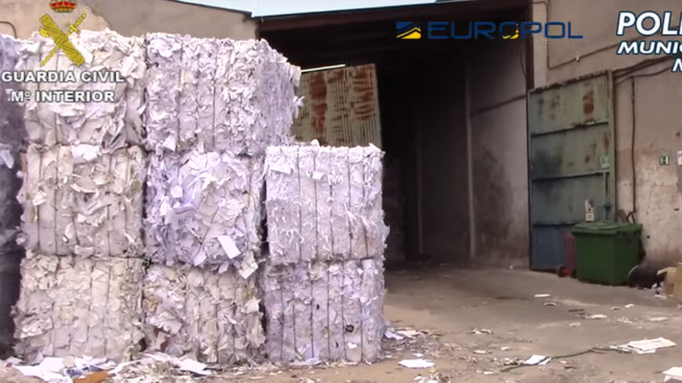 A picture of stacks of paper outside a waste processing plant in Madrid