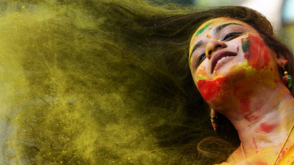 Woman with coloured powder in her hair