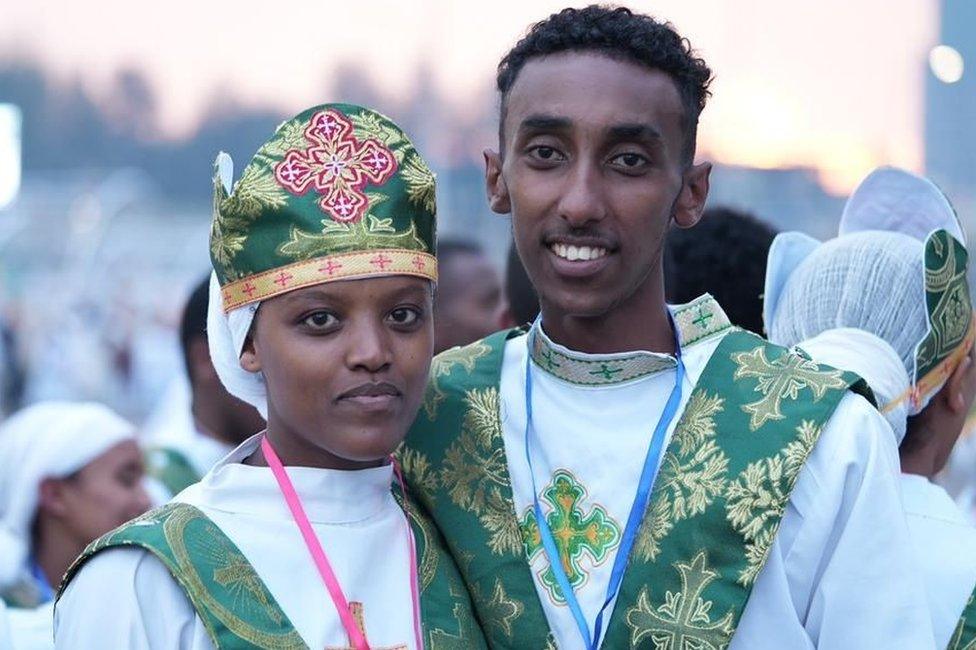 Man and woman in green and white