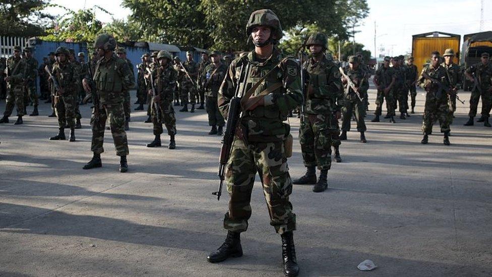 Members of the Nicaraguan army stand at the border between Nicaragua and Costa Rica on 15 November, 2015.