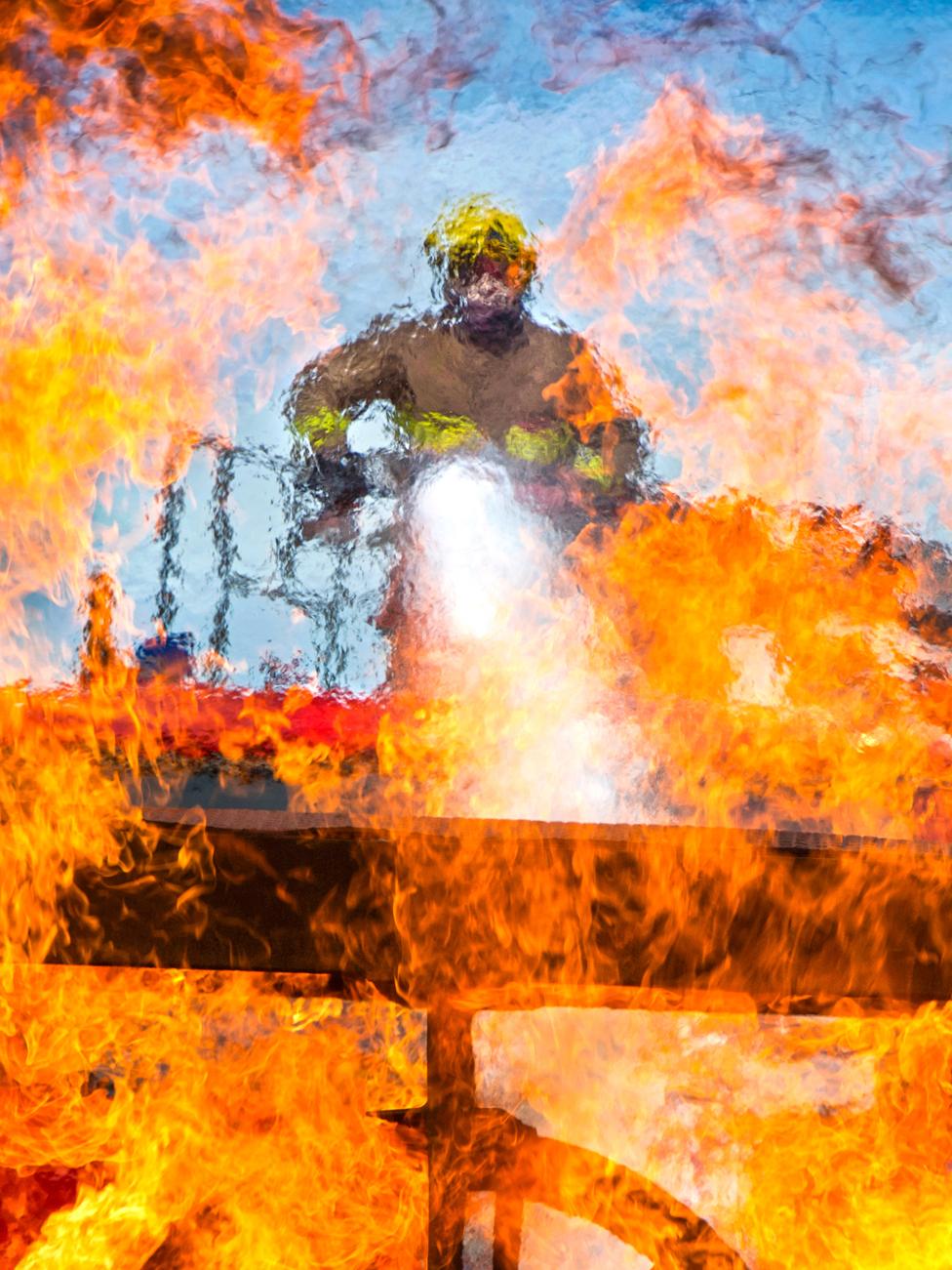 A fireman from RAF Shawbury fire and rescue department extinguishing flames