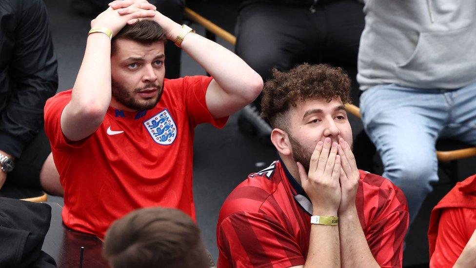 Two England fans watch the match at Boxpark in Croydon, south London