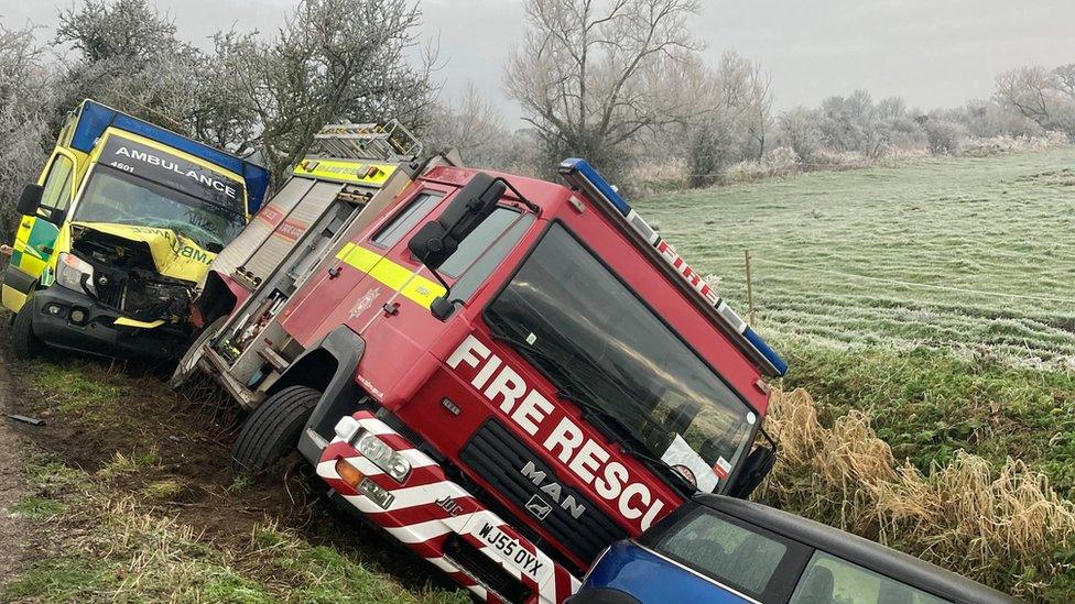 Emergency vehicles in a ditch