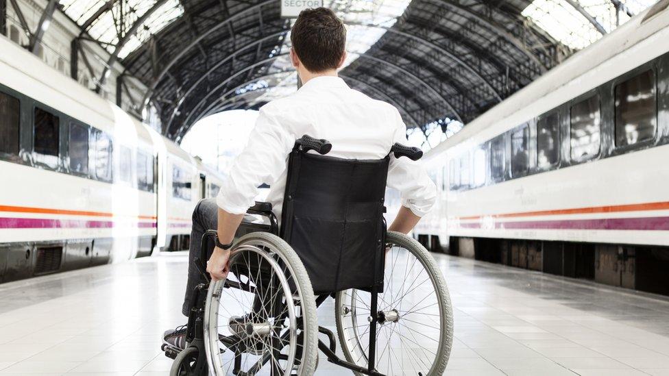 Man in wheelchair at train station