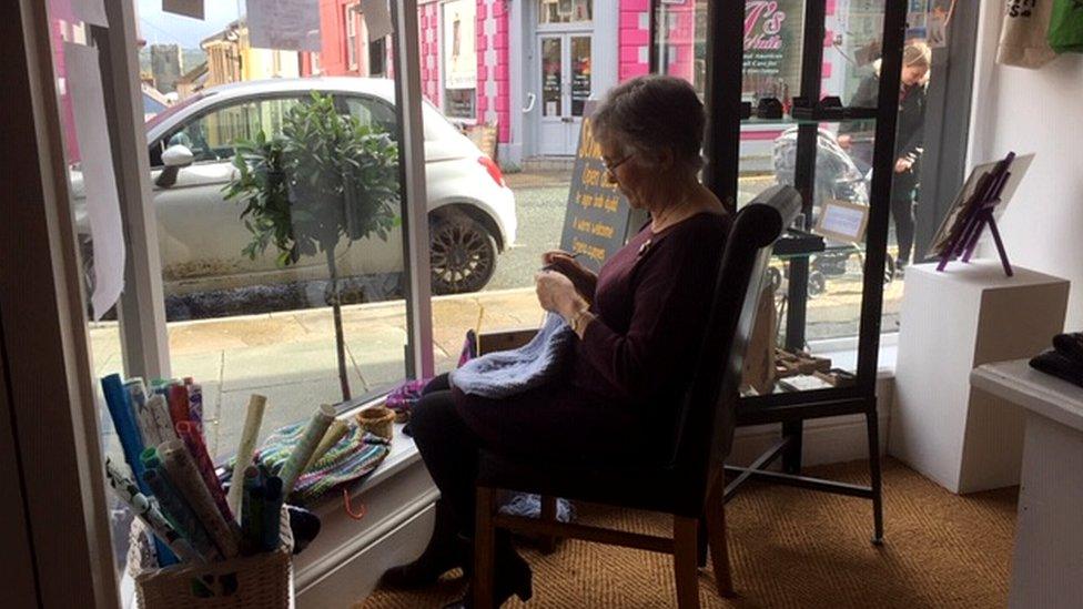 Eileen Johnson knitting in the cafe window