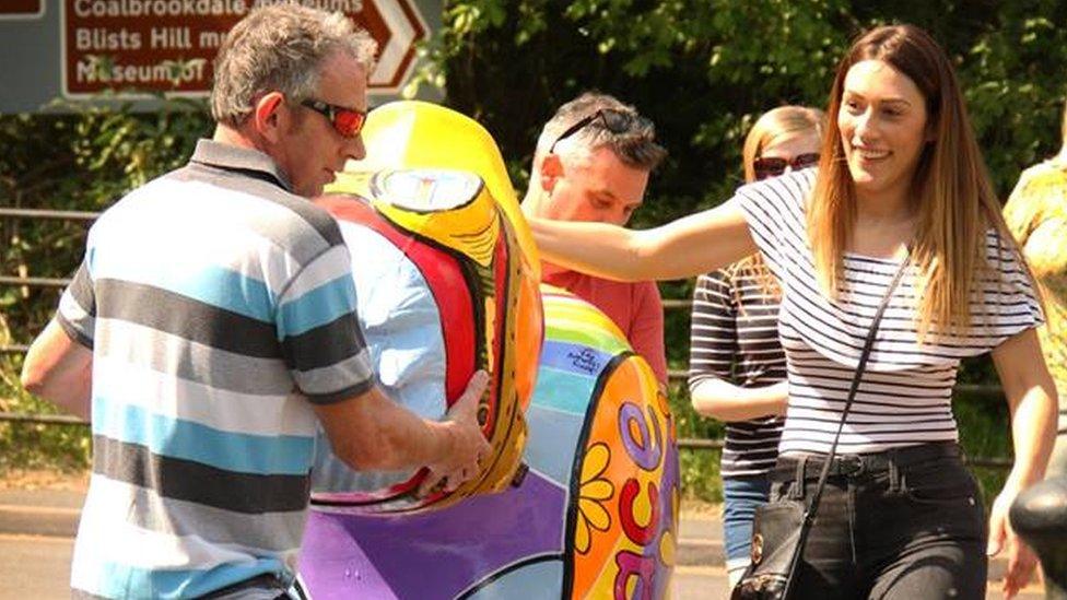 Volunteers moving the duck sculpture