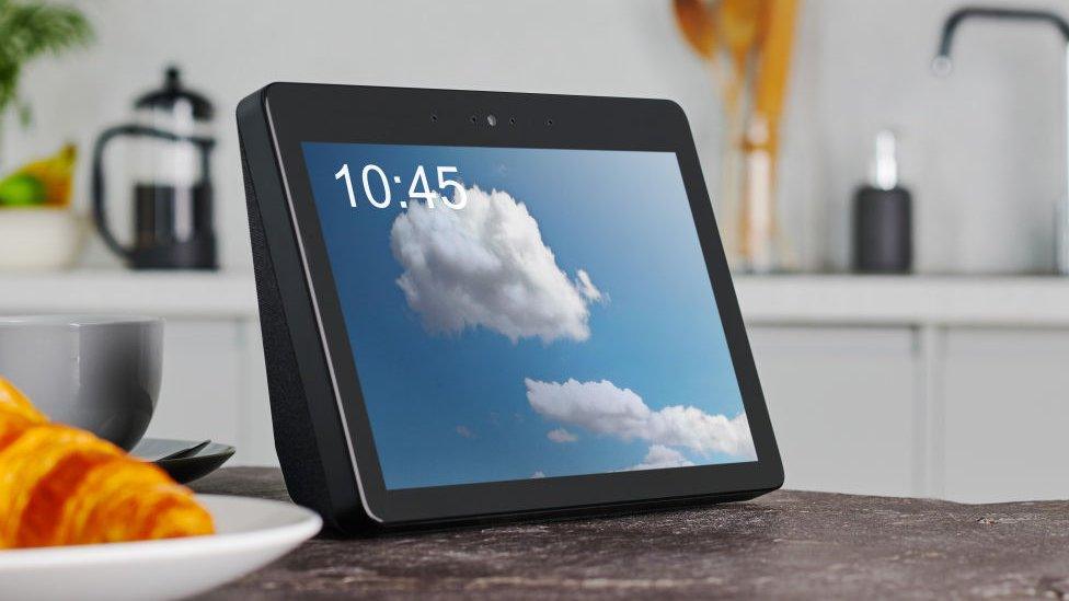 Amazon's Echo Show, is displayed on a kitchen counter with a cloud on its display