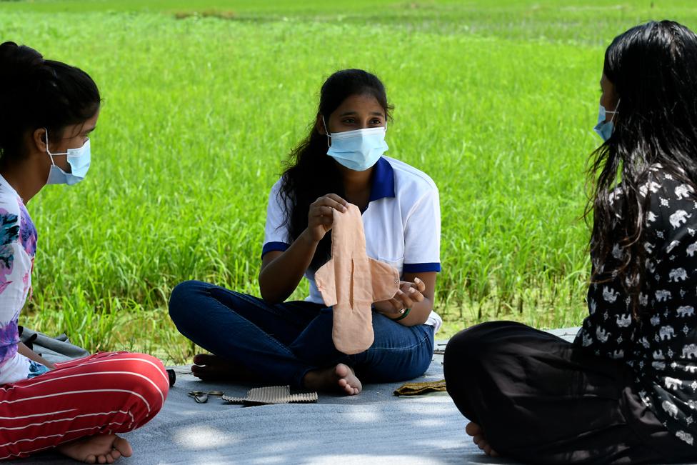 A group of people making a sanitary product