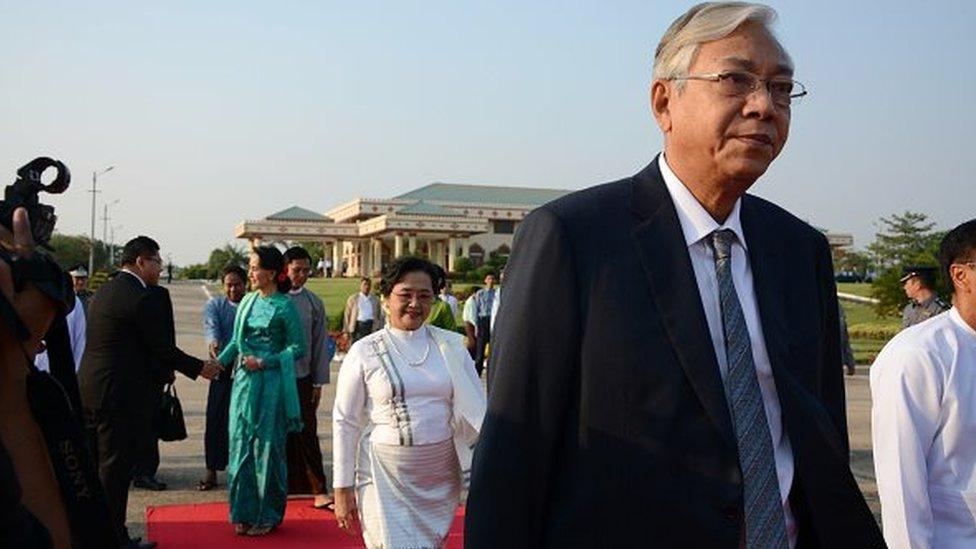 Myanmar President Htin Kyaw (R) followed by First Lady Su Su Lwin (C, in white dress) and State Counsellor and Foreign Minister Aung San Suu Kyi (L, in green dress) depart for an official trip to Laos from the Naypyidaw city airport on May 6, 2016