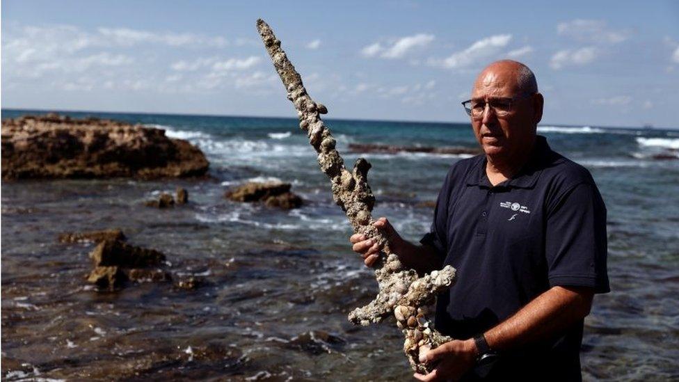 Kobi Sharvit of the IAA holds a sword believed to have belonged to a Crusader. October 18, 2021.