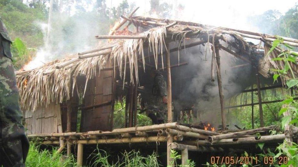 A hut begins to burn