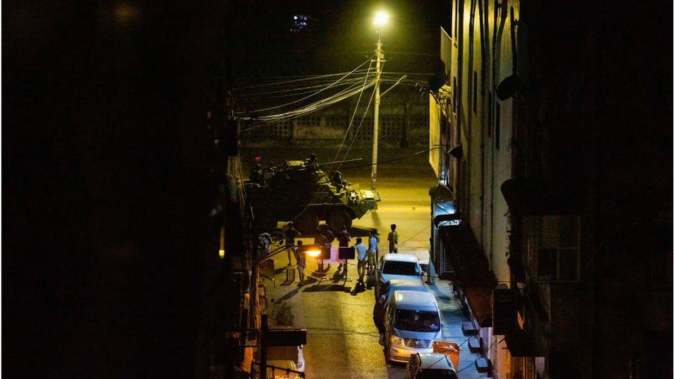 A military tank seen driving around the city at night during the military coup.