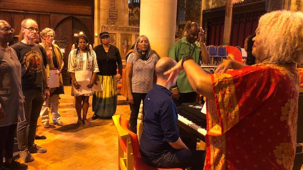 Choir being conducted by Gena Rose