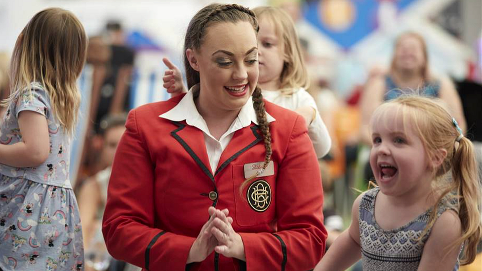 Butlin's worker with child