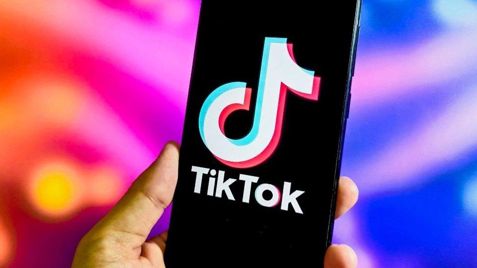 TikTok logo on a phone